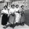 a group of women walking on a sidewalk